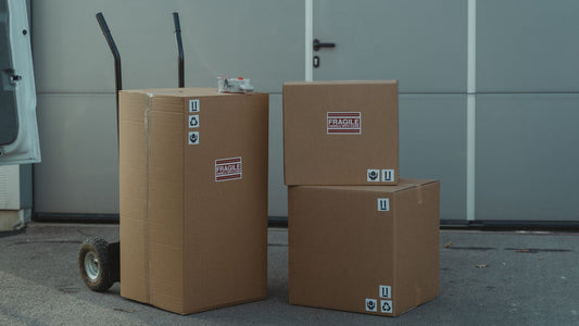 Boxes being moved with a dolly behind it